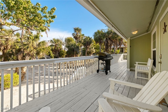 wooden deck with a grill