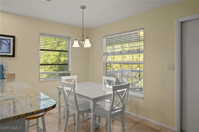 tiled dining area featuring a notable chandelier