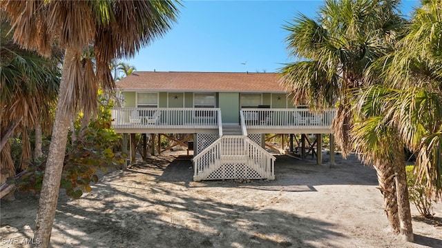 rear view of property with a carport and a porch