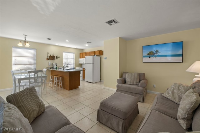 living room featuring light tile patterned floors and sink