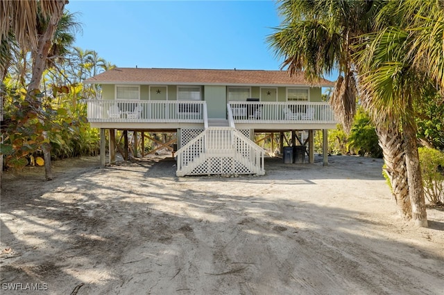 rear view of house with a carport and covered porch