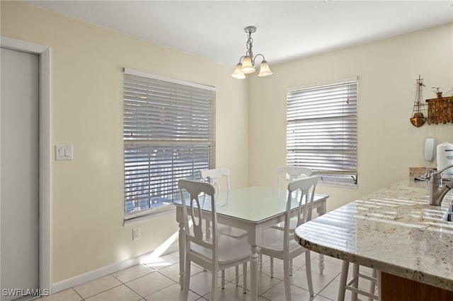 tiled dining area with plenty of natural light and a chandelier