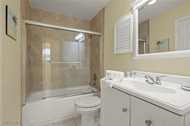 full bathroom featuring enclosed tub / shower combo, tile patterned floors, toilet, and vanity