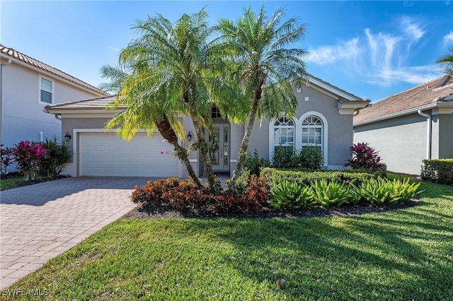 view of front of house with a garage and a front lawn