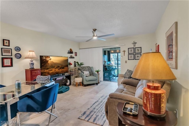 living room featuring a textured ceiling and ceiling fan