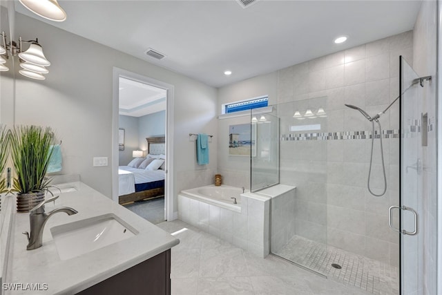 bathroom featuring vanity and separate shower and tub