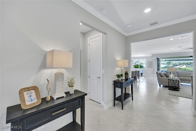 hall with crown molding and light tile patterned flooring