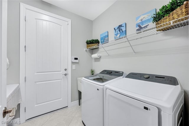 washroom with washing machine and clothes dryer