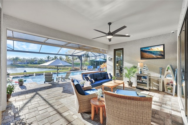 view of patio with a water view, ceiling fan, a lanai, and an outdoor hangout area