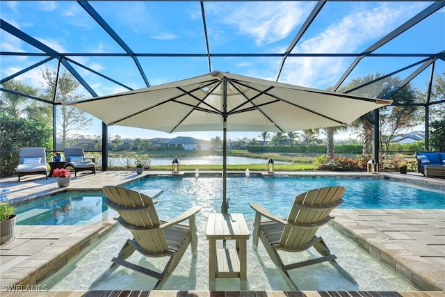 view of swimming pool with pool water feature, a patio, a water view, and glass enclosure