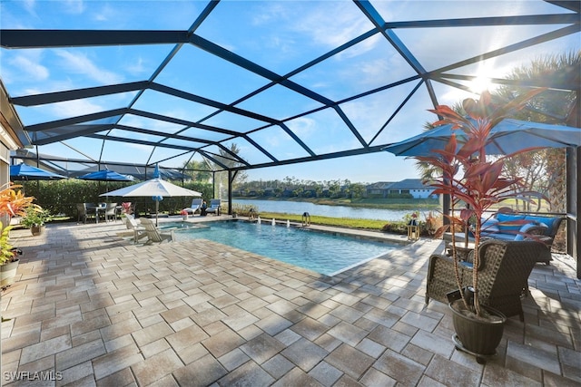 view of swimming pool featuring a water view, pool water feature, a lanai, and a patio