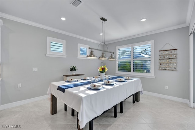 tiled dining room featuring crown molding