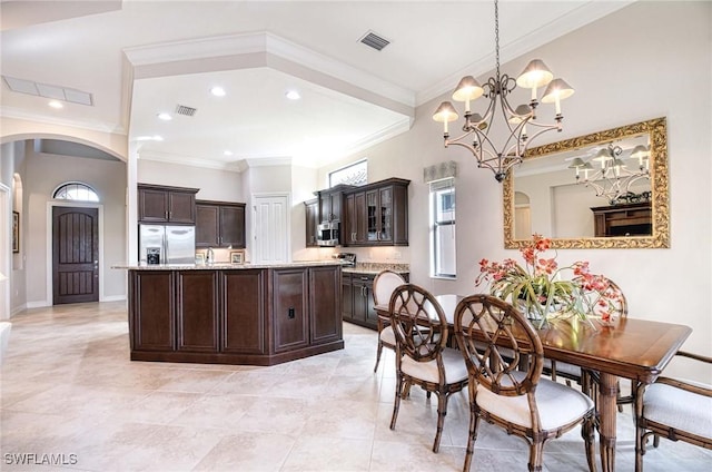 dining room featuring ornamental molding, light tile patterned floors, and a notable chandelier