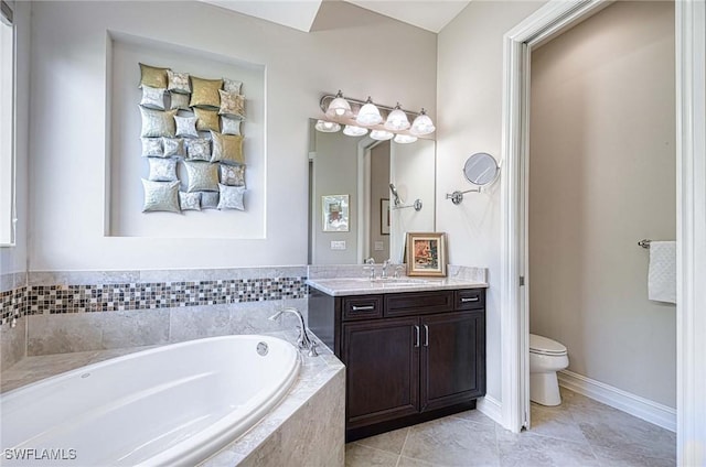 bathroom with vanity, a relaxing tiled tub, tile patterned floors, and toilet