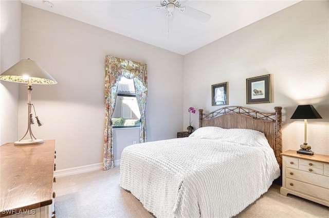 bedroom featuring light colored carpet and ceiling fan