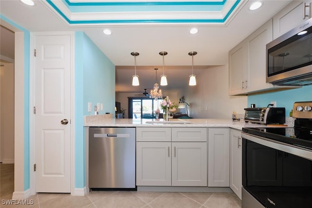 kitchen featuring light tile patterned flooring, sink, pendant lighting, stainless steel appliances, and light stone countertops