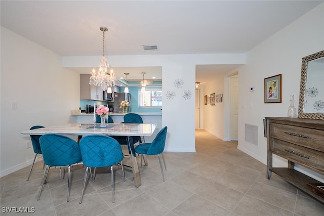 tiled dining room featuring a notable chandelier