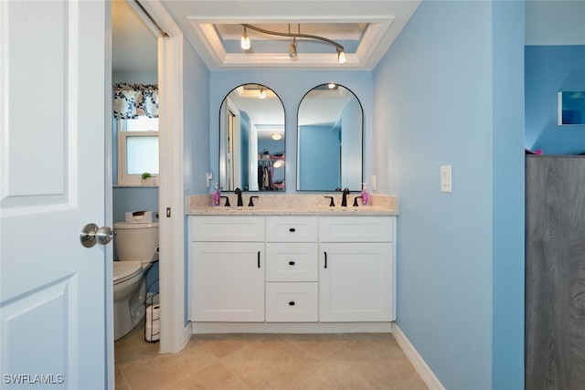 bathroom featuring a raised ceiling, vanity, tile patterned flooring, and toilet