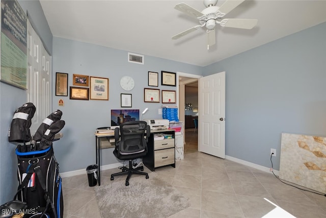 tiled office space featuring ceiling fan