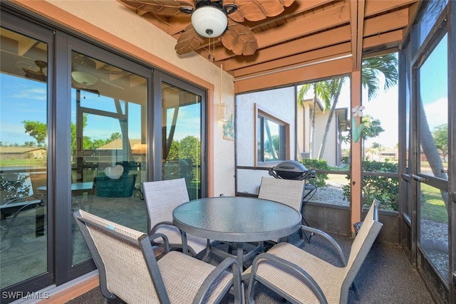 sunroom / solarium featuring ceiling fan and plenty of natural light