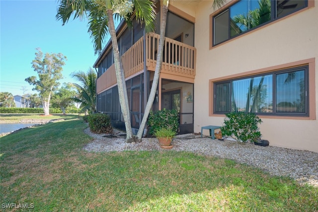 rear view of house featuring a lawn