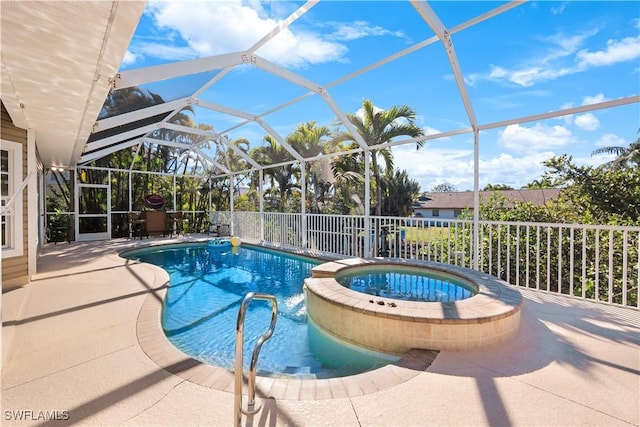 view of pool featuring an in ground hot tub, glass enclosure, and a patio