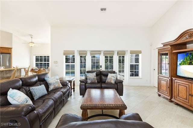 tiled living room featuring ceiling fan