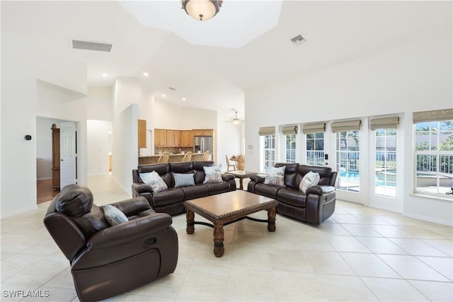 living room featuring light tile patterned floors and high vaulted ceiling