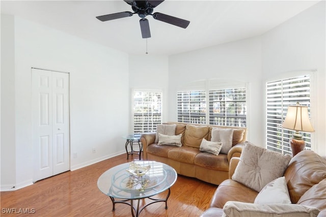 living room with ceiling fan and light wood-type flooring