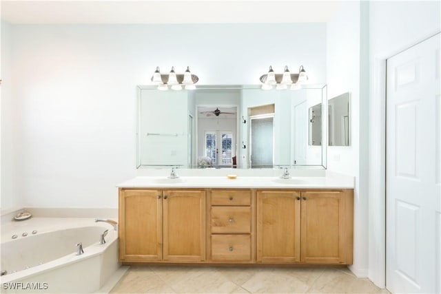 bathroom with vanity, ceiling fan, and a tub to relax in