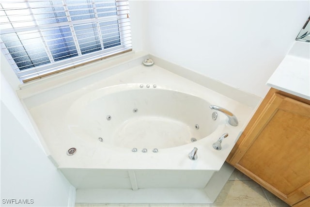 bathroom with a bathing tub and vanity