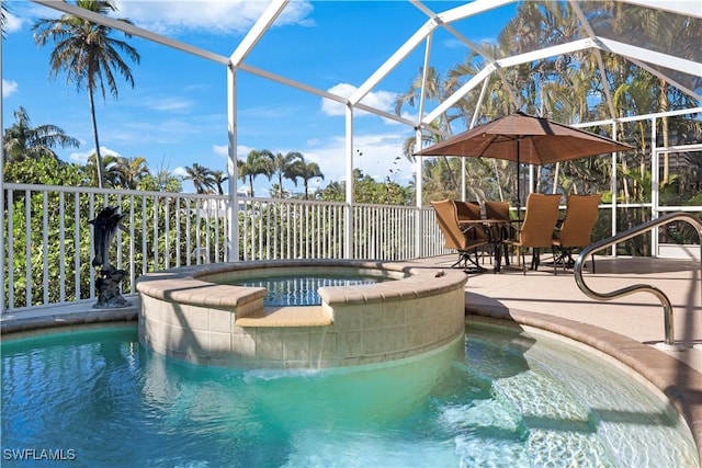 view of pool with a patio, glass enclosure, and an in ground hot tub