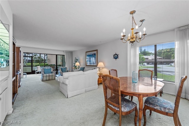 carpeted dining room featuring an inviting chandelier