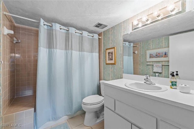 bathroom with tile patterned flooring, vanity, a textured ceiling, curtained shower, and toilet