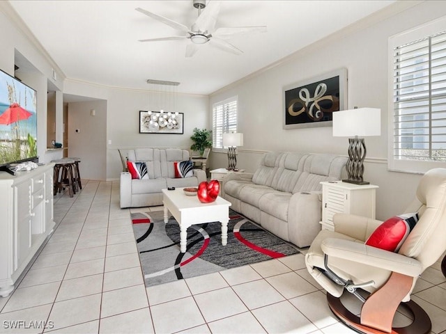 tiled living room with crown molding and ceiling fan