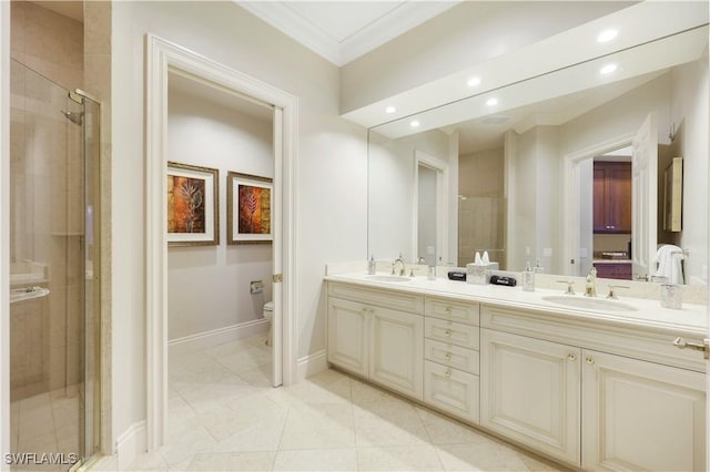 bathroom featuring vanity, a shower with shower door, ornamental molding, and toilet