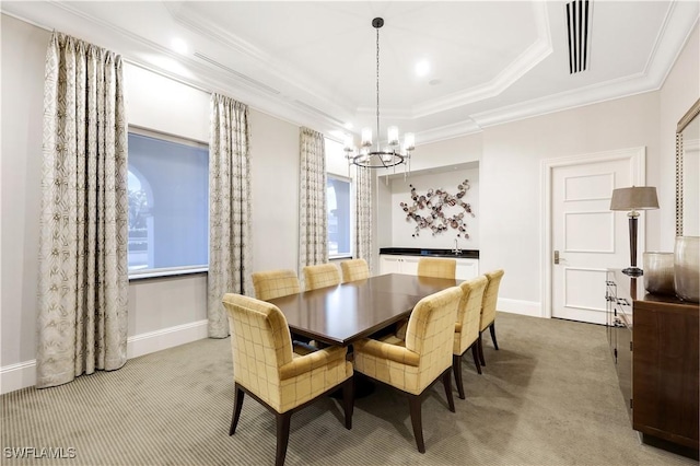 dining area with ornamental molding, carpet, plenty of natural light, and a chandelier