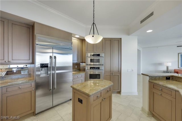 kitchen featuring pendant lighting, stainless steel appliances, crown molding, and light stone counters