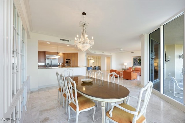 dining space featuring an inviting chandelier and crown molding