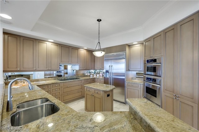 kitchen with sink, appliances with stainless steel finishes, hanging light fixtures, a center island, and light stone countertops