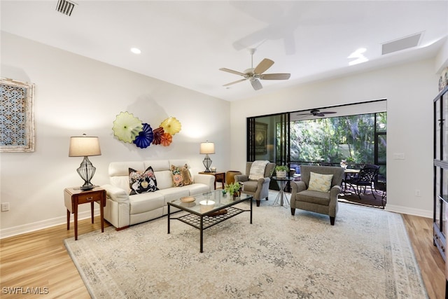 living room featuring wood-type flooring and ceiling fan