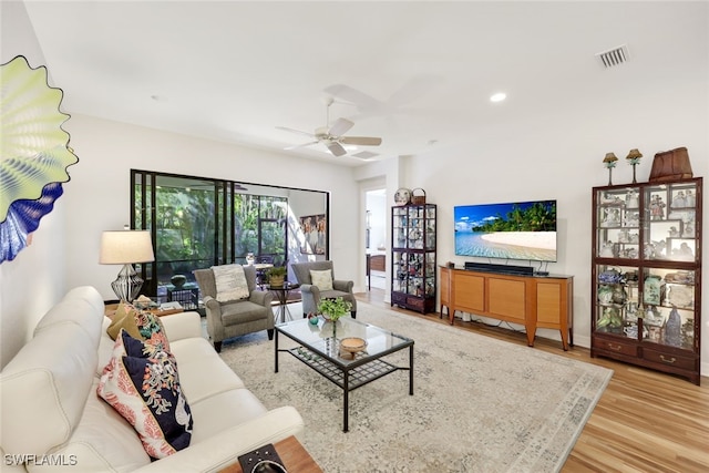 living room featuring ceiling fan and light wood-type flooring