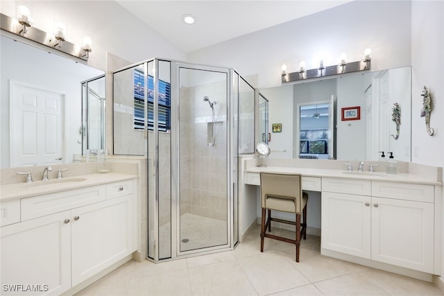 bathroom with tile patterned floors, a shower with door, and vanity