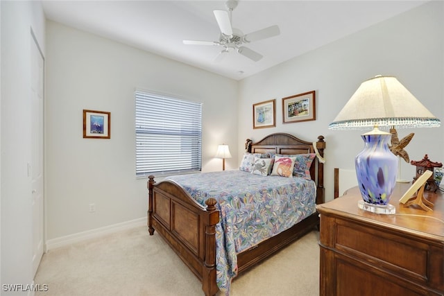 bedroom featuring light colored carpet and ceiling fan