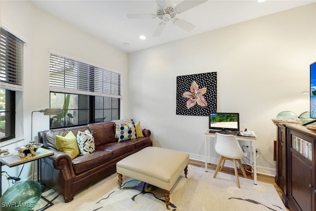 living room with ceiling fan and light wood-type flooring