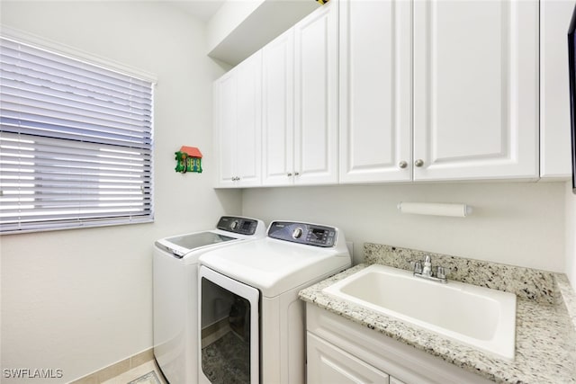 laundry room with sink, cabinets, and washing machine and clothes dryer