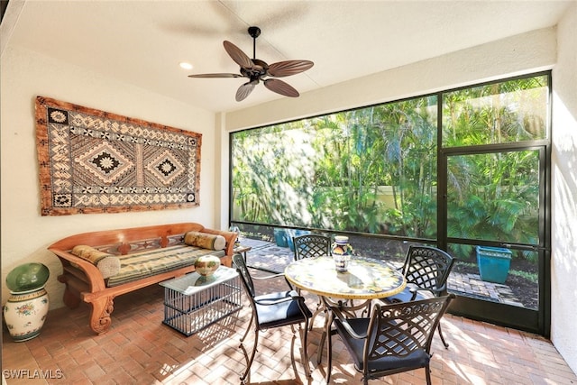 sunroom / solarium featuring a wealth of natural light and ceiling fan