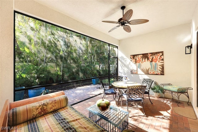 sunroom / solarium featuring ceiling fan