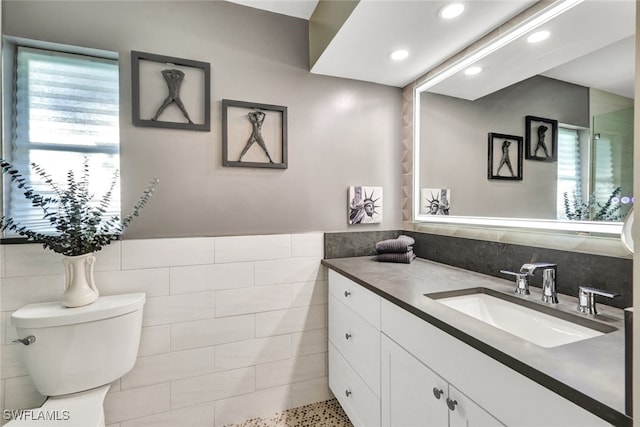 13 Pelican St W, Naples, FL 34113 - bathroom with tile walls, vanity, and toilet