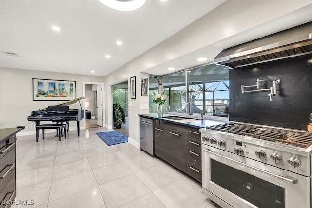 13 Pelican St W, Naples, FL 34113 - kitchen with sink, light tile patterned floors, appliances with stainless steel finishes, dark brown cabinets, and decorative backsplash